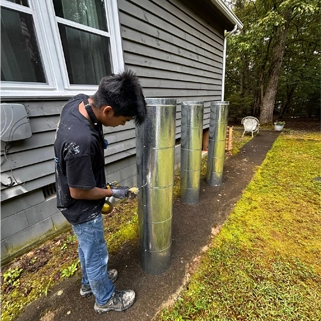 Professional HVAC Technicians at Work on Duct Installation