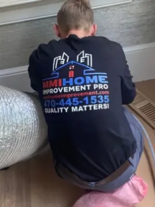 MMI Home Improvement Pro technician performing residential air duct cleaning at a home in Acworth, GA