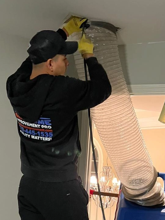 Technician performing air duct cleaning service in Atlanta,GA home