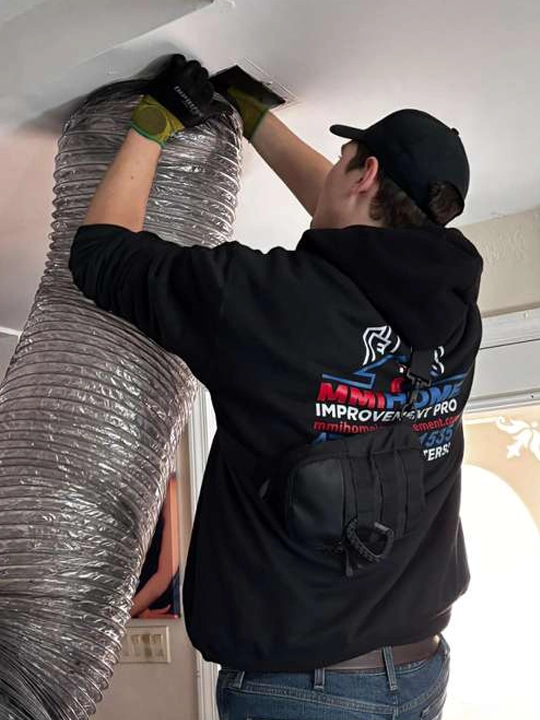 Technician performing residential air duct cleaning service in Buford, GA