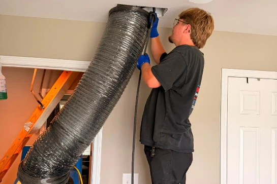 MMI-Technician-Cleaning-Dust-Hiding-Inside-the-Home Ventilation-System